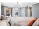 Bright bedroom with a king-size bed and access to the balcony and bathroom at 10817 Tarflower Dr # 202, Venice, FL 34293