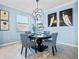 Modern dining room with a round table and patterned chairs at 10817 Tarflower Dr # 202, Venice, FL 34293