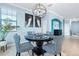 Modern dining room with a round table and patterned chairs at 10817 Tarflower Dr # 202, Venice, FL 34293
