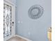 Front entry with decorative glass door and mirror at 10817 Tarflower Dr # 202, Venice, FL 34293