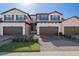Three-story townhouses with brown garages and landscaped yards at 10817 Tarflower Dr # 202, Venice, FL 34293