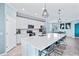 Modern kitchen with white cabinets, quartz countertops, and stainless steel appliances at 10817 Tarflower Dr # 202, Venice, FL 34293