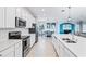 Modern kitchen with white cabinets and stainless steel appliances at 10817 Tarflower Dr # 202, Venice, FL 34293