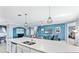 Open concept kitchen with island and seating overlooking the living room at 10817 Tarflower Dr # 202, Venice, FL 34293