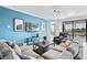 Living room with sectional sofa and access to balcony at 10817 Tarflower Dr # 202, Venice, FL 34293