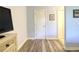 Light and bright hallway with wood-look flooring and access to other rooms at 11058 Deerwood Ave, Englewood, FL 34224