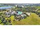 Community pool, playground, and sports court in a lush setting at 12689 Promenade Estates Blvd, Sarasota, FL 34238