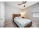 Cozy bedroom with a queen-size bed and ceiling fan at 12689 Promenade Estates Blvd, Sarasota, FL 34238