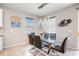 Modern dining area with glass top table and black chairs at 12689 Promenade Estates Blvd, Sarasota, FL 34238