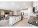 Open concept kitchen with island and granite countertops at 12689 Promenade Estates Blvd, Sarasota, FL 34238