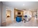 Open living room with a wood accent wall, tile floors, and access to other rooms at 12689 Promenade Estates Blvd, Sarasota, FL 34238