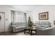 Spacious living room with gray leather sofas and a charming Christmas tree at 13368 Englewood Rd, Port Charlotte, FL 33981