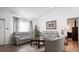 Living area with gray sofas, a coffee table, and a view of the dining area at 13368 Englewood Rd, Port Charlotte, FL 33981