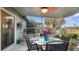 Relaxing screened porch with glass table, chairs, and lush greenery at 13368 Englewood Rd, Port Charlotte, FL 33981