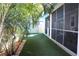 Spacious backyard with artificial turf and tropical landscaping at 1421 14Th N St, St Petersburg, FL 33704