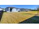 Large backyard with grass and a view of neighboring homes at 148 Whiteland Bnd, Nokomis, FL 34275