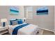 Bedroom with a queen bed and blue accents at 148 Whiteland Bnd, Nokomis, FL 34275