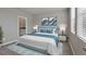 Spacious bedroom with light blue bed and en-suite bathroom at 148 Whiteland Bnd, Nokomis, FL 34275