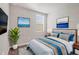 Bright bedroom with a queen-size bed and stylish decor at 148 Whiteland Bnd, Nokomis, FL 34275