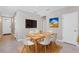Dining area with wood table and six white chairs at 148 Whiteland Bnd, Nokomis, FL 34275