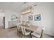 Elegant dining room with wood table, chandelier and view to backyard at 1496 Sunset Preserve Way, Port Charlotte, FL 33953