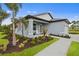 One-story home with gray siding, landscaping, and a paved walkway at 1496 Sunset Preserve Way, Port Charlotte, FL 33953