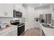 Modern kitchen with stainless steel appliances and white shaker cabinets at 1496 Sunset Preserve Way, Port Charlotte, FL 33953