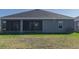 House with screened porch and grassy backyard at 16128 67Th E Ct, Parrish, FL 34219