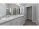 Double vanity bathroom with granite countertops and large mirror at 16128 67Th E Ct, Parrish, FL 34219