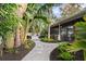 Landscaped backyard with a winding pathway and lush foliage at 1815 Grove St, Sarasota, FL 34239