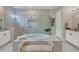 Luxurious bathroom with a large soaking tub, glass shower, and double vanity at 18212 Cayo Largo Pl, Bradenton, FL 34202