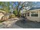 Backyard view showcasing patio, landscaping, and a fire pit at 2072 Misty Sunrise Trl, Sarasota, FL 34240