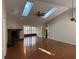 Bright living room with high ceilings, skylights, a fireplace, and wood flooring at 2072 Misty Sunrise Trl, Sarasota, FL 34240