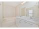 Bright bathroom features a double vanity, large mirror, and bathtub at 2073 Damascus Ln, Punta Gorda, FL 33983