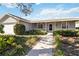 Single-story home with covered porch and landscaped yard at 210 20Th W St, Bradenton, FL 34205