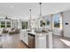 Bright kitchen with white cabinetry, an island, and views into adjacent living areas at 274 Via Anina Dr, Sarasota, FL 34243