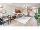 Bright living room featuring a grey sofa, wood-look floors, and large artwork at 274 Via Anina Dr, Sarasota, FL 34243