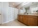 Bathroom with double vanity and a floral shower curtain at 28214 Arrowhead Cir, Punta Gorda, FL 33982