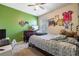 bedroom with green wall, a bed, and gaming decor at 28214 Arrowhead Cir, Punta Gorda, FL 33982
