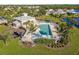 Aerial view of community pool with lounge chairs and palm trees at 28214 Arrowhead Cir, Punta Gorda, FL 33982