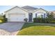 Single-story house with a two-car garage and well-manicured lawn at 28214 Arrowhead Cir, Punta Gorda, FL 33982