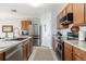 Modern kitchen with stainless steel appliances and light wood cabinets at 28214 Arrowhead Cir, Punta Gorda, FL 33982