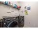 Laundry room with washer, dryer, and shelving for storage at 28214 Arrowhead Cir, Punta Gorda, FL 33982