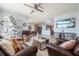 Open living space with leather furniture, a Christmas tree and kitchen view at 28214 Arrowhead Cir, Punta Gorda, FL 33982