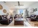 Living room with leather furniture, a Christmas tree, and large windows at 28214 Arrowhead Cir, Punta Gorda, FL 33982