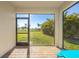 Screened-in porch overlooking a backyard with tropical landscaping at 28214 Arrowhead Cir, Punta Gorda, FL 33982