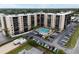 Aerial view of a large apartment building with a pool and ample parking at 2901 26Th W St # 601, Bradenton, FL 34205