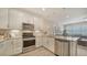 Modern kitchen with stainless steel appliances and white cabinets at 3331 Chestertown Loop, Lakewood Ranch, FL 34211