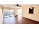 Living room with tile floors, sliding door to patio, and kitchen pass-through at 3419 Clark Rd # 120, Sarasota, FL 34231