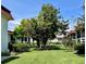 Landscaped lawn with mature trees and shrubs at 3504 Beneva Rd # 206, Sarasota, FL 34239
